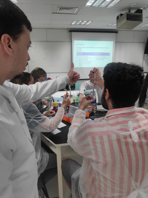 A teacher learning how to use the micropipette