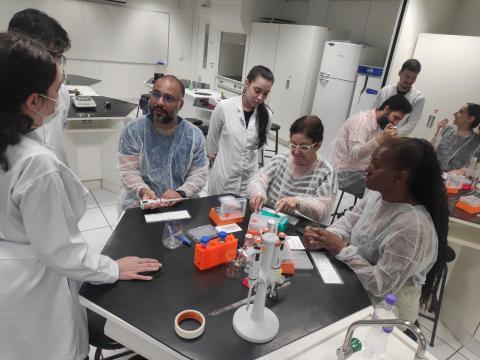 Two benches with teachers learning about the lab equipment we use for ABE