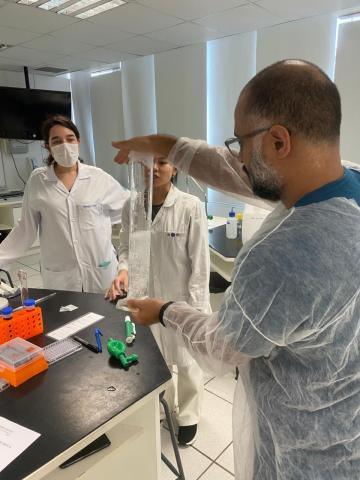 Um professor usando uma proveta para diluir o tampão